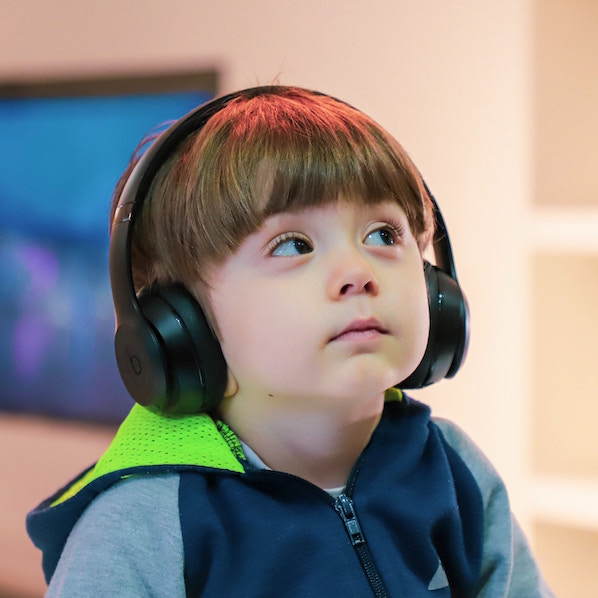 boy wearing large headphones looking up