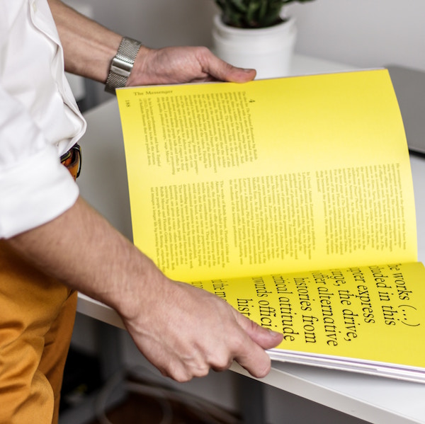 person holding a document with large print