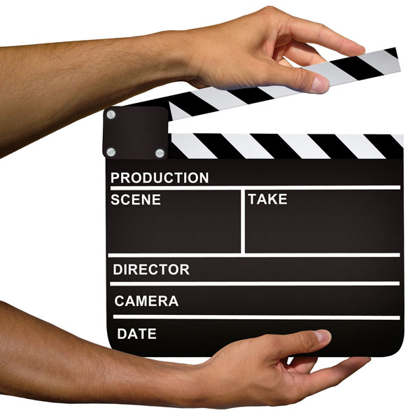 hands holding a Hollywood-style clapper board