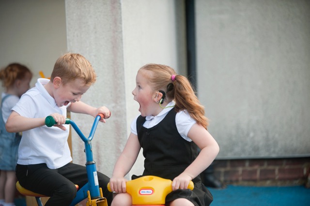 deaf children playing on bikes
