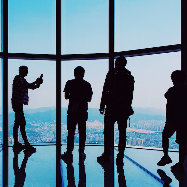 silhouettes of people standing and discussing